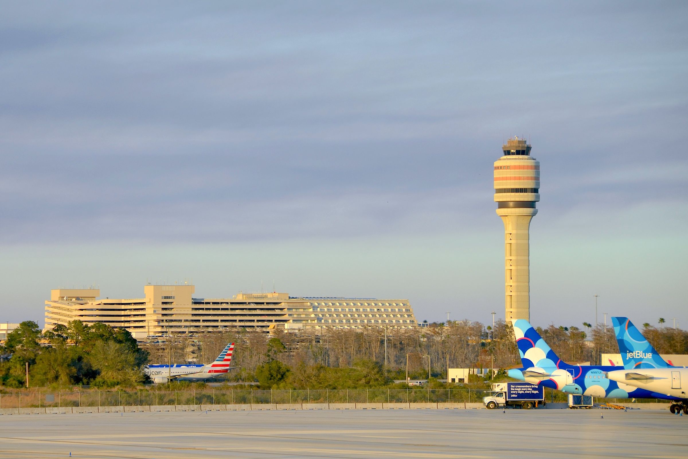 The air traffic control tower at Orlando International Airport rising above the terminal.